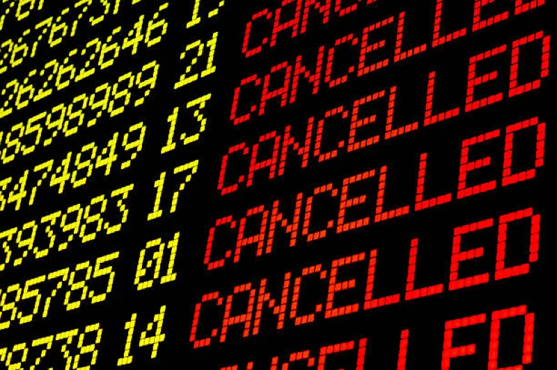 flight information board showing multiple cancelled flights
